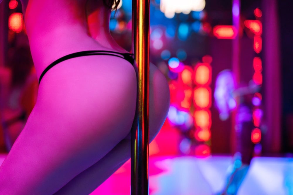 Girl doing pole dance in strip club