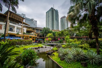 View of the Greenbelt Park against the backdrop of Manila's skyscrapers