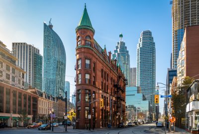 Gooderham or Flatiron Building in Toronto with skyscrapers at the background