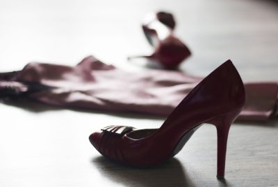 Red pumps and lingerie of Dusseldorf escort thrown on the floor 