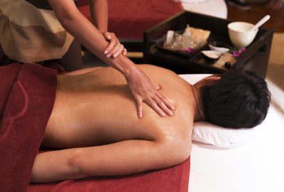 Man receiving back massage in Asian massage salon in Florence