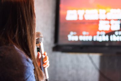 Japanese lady singing karaoke in KTV bar in downtown Tokyo