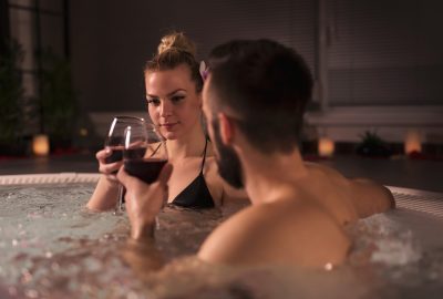 Couple sipping wine in jacuzzi of Vienna FKK club