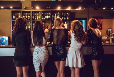 Serbian girls ordering drinks at bar of club in Belgrade
