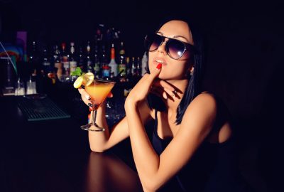 Freelance escort enjoying a cocktail at bar in Ibiza club