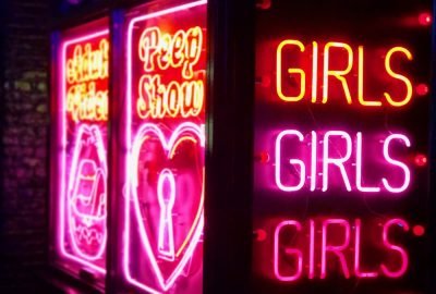 Neon lights advertising peep shows in Soho