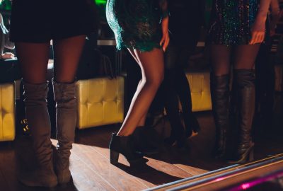 Leggy girls standing near dance floor in Marbella night club