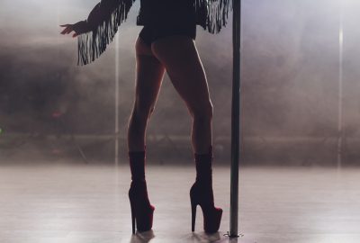 Pole dancer in dimmed light in striptease club in Palma de Mallorca