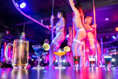 Thai girls dancing around poles in Pattaya go-go club 