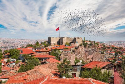 Ankara Castle beneath a flock of birds and panorama view of Ankara