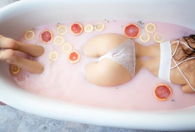 Girl taking a bath with grapefruit and lemons in Balinese massage and spa salon