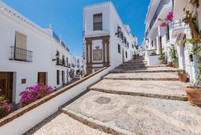 Charming narrow historic street of the white village of Frigiliana in the province of Malaga, Andalusia
