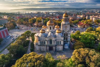 Varna's Dormition of the Mother of God Cathedral with Black Sea and port area on the background